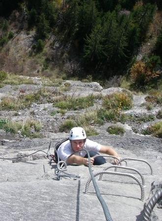 Moving up metal rungs on a via ferrata